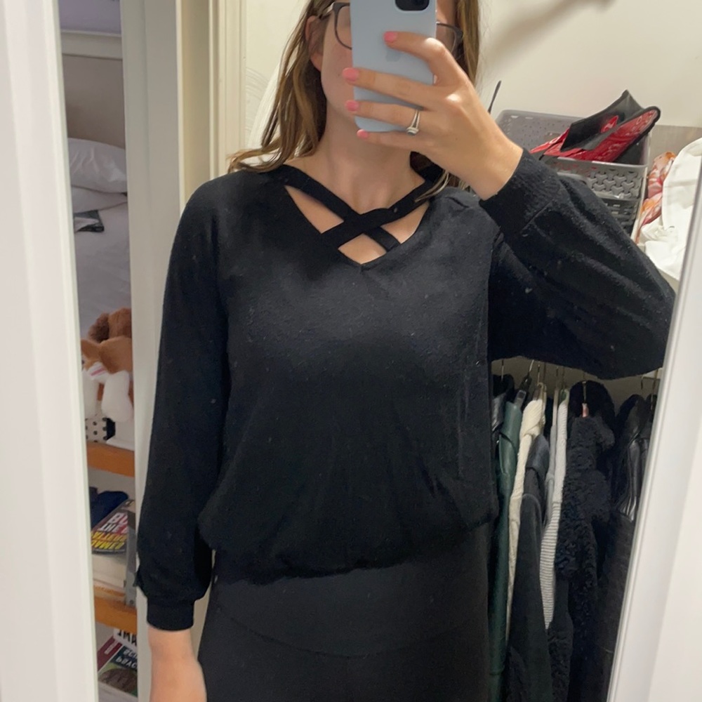 Black sweater with cross at neck